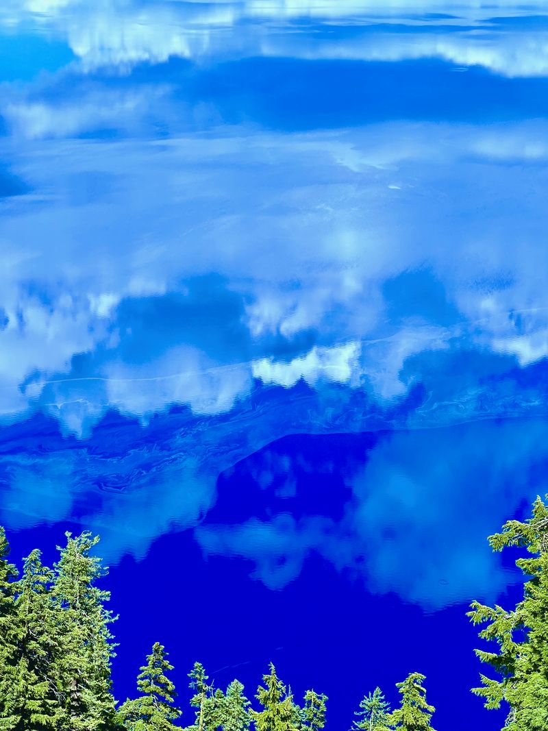 The sky inverted against crater lake.