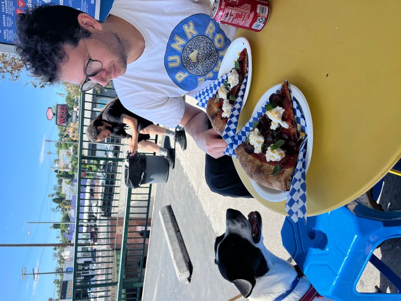 David considering sharing a slice of pizza with Cowboy.