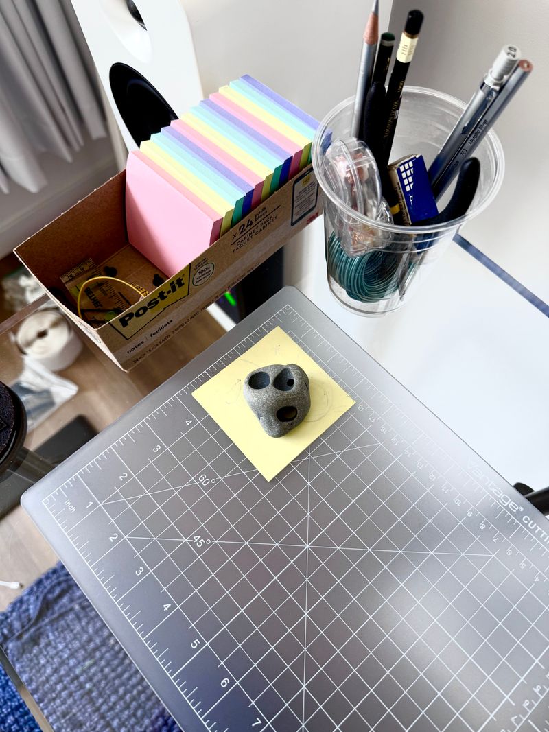 A hole'd rock sitting on a transparent grid.